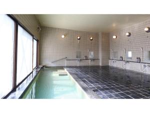 a large bathroom with a swimming pool and mirrors at Hotel Silk in Madarao - Vacation STAY 79656v in Iiyama