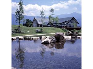 a house sitting on top of a body of water at Hotel Silk in Madarao - Vacation STAY 79648v in Iiyama