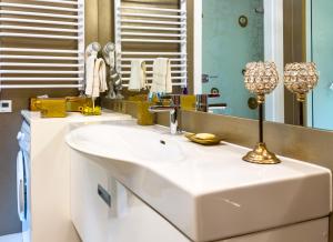 a bathroom with a white sink and a mirror at Apartament Cesarski in Cieszyn