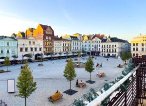 a city with people sitting on benches in a plaza at Apartament Cesarski in Cieszyn