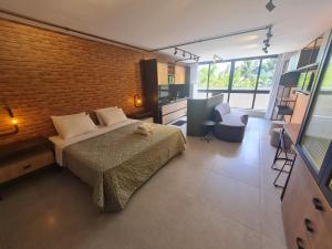 a bedroom with a bed and a brick wall at URBAN 750 TAMBAU Flat in João Pessoa