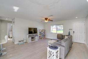 a living room with a couch and a ceiling fan at Fort Myers Vacation Home with Patio about 14 Mi to Beach in Fort Myers