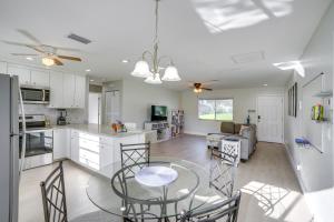 a kitchen and living room with a table and chairs at Fort Myers Vacation Home with Patio about 14 Mi to Beach in Fort Myers