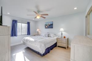 a bedroom with a bed and a ceiling fan at Fort Myers Vacation Home with Patio about 14 Mi to Beach in Fort Myers