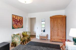 a living room with a couch and a wooden cabinet at BB Ikast in Ikast