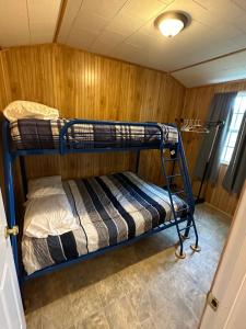 a bedroom with two bunk beds in a room at Cypress Landing Cabins 