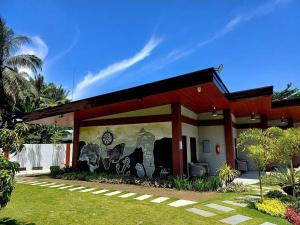 a building with a mural on the side of it at Swissfinity Beach Resort in Pangubatan