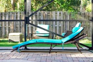 a couple of chairs sitting next to a fence at Poolside Cocoa Oasis w/ Tiki Bar! in Frontenac