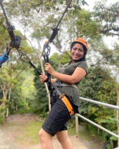 a woman on a zip line in the jungle at Hostal Henrry's in Mindo