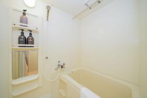 a bathroom with a sink and a bath tub at Residence KABUTO 124 - Vacation STAY 15508 in Sapporo