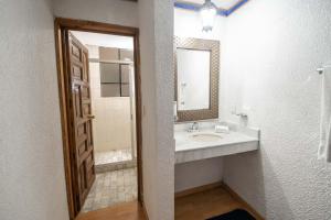 a bathroom with a sink and a mirror at Hotel Rincon de Josefa in Pátzcuaro