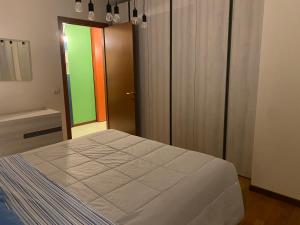 Dormitorio con cama grande y puerta colorida en Il Principio - zona Fiera e Policlinico, en Pordenone