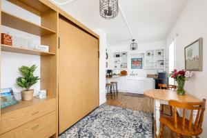 a room with a wooden door leading into a kitchen at The City Roost at Timberline Flats with Balcony in Traverse City