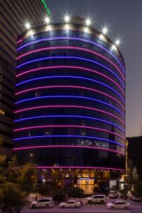 a blue building with cars parked in front of it at Montana Al Azizia Hotel in Mecca