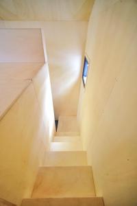 a staircase in a house with a small window at Modern Tiny House 
