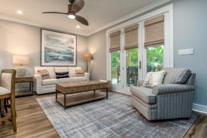 a living room with a couch and a table at Island Soul Waterlemon Cay Villa - Unit 1 - 500 Lemoyne condo in Dauphin Island