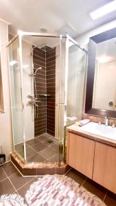 a bathroom with a shower and a sink at Хайвилл Астана in Astana
