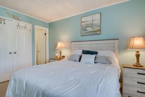 a bedroom with a large white bed with two lamps at Ocean City Condo - Steps to Beach! in Ocean City