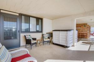 a living room with a couch and chairs and windows at Ocean City Condo - Steps to Beach! in Ocean City