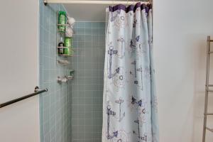 a shower with a shower curtain in a bathroom at Ocean City Condo - Steps to Beach! in Ocean City +16 photos