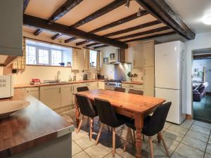 a kitchen with a wooden table and chairs at Gale Lodge Cottage in Ambleside