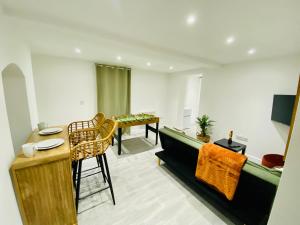 a living room with a couch and a table at No 1 - Central Apartment in Gloucester