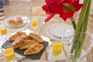 a table with a vase of flowers and a plate of pastries at 2 Bedroom Flat - Free Parking - Close to Beach in Portsmouth