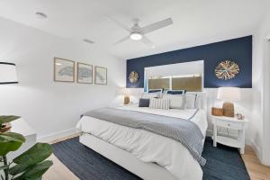 a bedroom with a bed and a blue accent wall at Vista Del Mar Oceanfront Home Stunning Views Backyard Oasis in Cocoa Beach