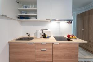 a kitchen with a sink and a bowl of fruit at Praia da Rocha Beach Bright Apartment 50 m walk from the ocean in Portimão