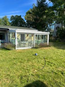 a house with a screened in porch and a yard at Haus Elli 