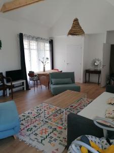 a living room with a couch and a table at LA MAISON BLEUE in Quiberon