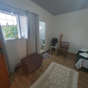a living room with a couch and a window at Casa de Campo Chalé Saturno in Alto Paraíso de Goiás