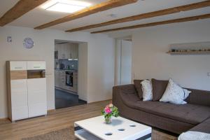 a living room with a couch and a table at Ferienwohnung Bauernhaus in Balingen