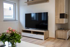 a flat screen tv sitting on a stand in a living room at Ferienwohnung Bauernhaus in Balingen