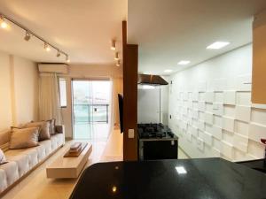 a living room with a couch and a stove at 30 secs to the beach, 3 balconies, 2 bdrms ensuite in Rio de Janeiro