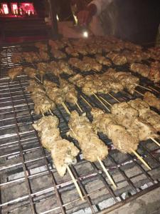 a bunch of chickens cooking on a grill at jenylyn`s chalet` families only` in Ain Sokhna