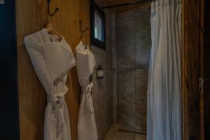 a bathroom with white curtains and a shower at Reserva Natural Iguazú - Pristine Luxury Camp in Puerto Libertad