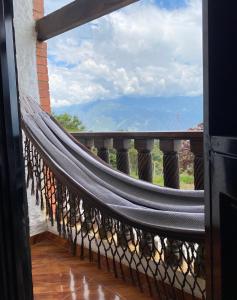 a hammock on a balcony with a view at Montañita del Río in Aratoca