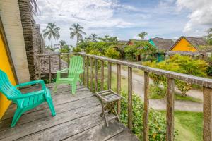 a deck with two chairs and a table at Selina Playa Venao in Playa Venao