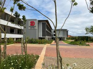 a building with a speed limit sign next to a road at Zimbali Lakes Boulevard Suites 220 in Ballito