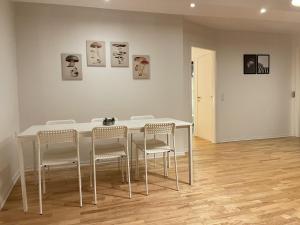 a dining room with a white table and chairs at aday - Large terrace and 2 bedrooms apartment in the heart of Randers in Randers