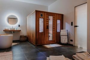 a bathroom with a tub and a sink and a toilet at Queen's Avenue, Wellness and free station E-Car in Spa