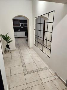 a hallway with a mirror and a potted plant at RG Apartments in Šamorín +2 photos
