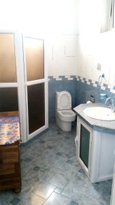 a bathroom with a toilet and a sink and a toilet istg at 2 bedrooms house with furnished terrace and wifi at Fond du Sac 5 km away from the beach in Fond du Sac