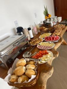 a long table filled with different types of food at Pousada Canouan in Japaratinga