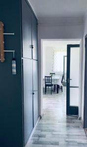 a hallway with a door and a dining room at Füred Apartman in Balatonfüred