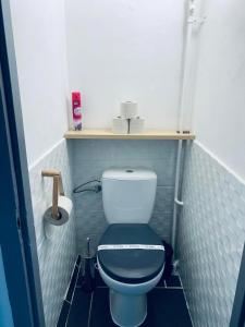 a small bathroom with a toilet with a blue tiled floor at Füred Apartman in Balatonfüred