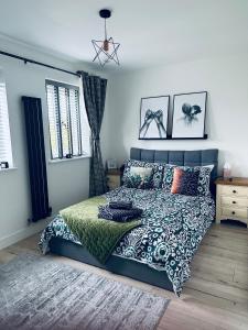 a bedroom with a bed and pillows on it at The Ely Retreat in Ely