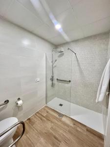 a bathroom with a shower with a glass door at Lofts IFEMA in Madrid