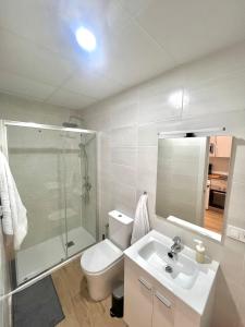 a bathroom with a toilet and a shower and a sink at Lofts IFEMA in Madrid